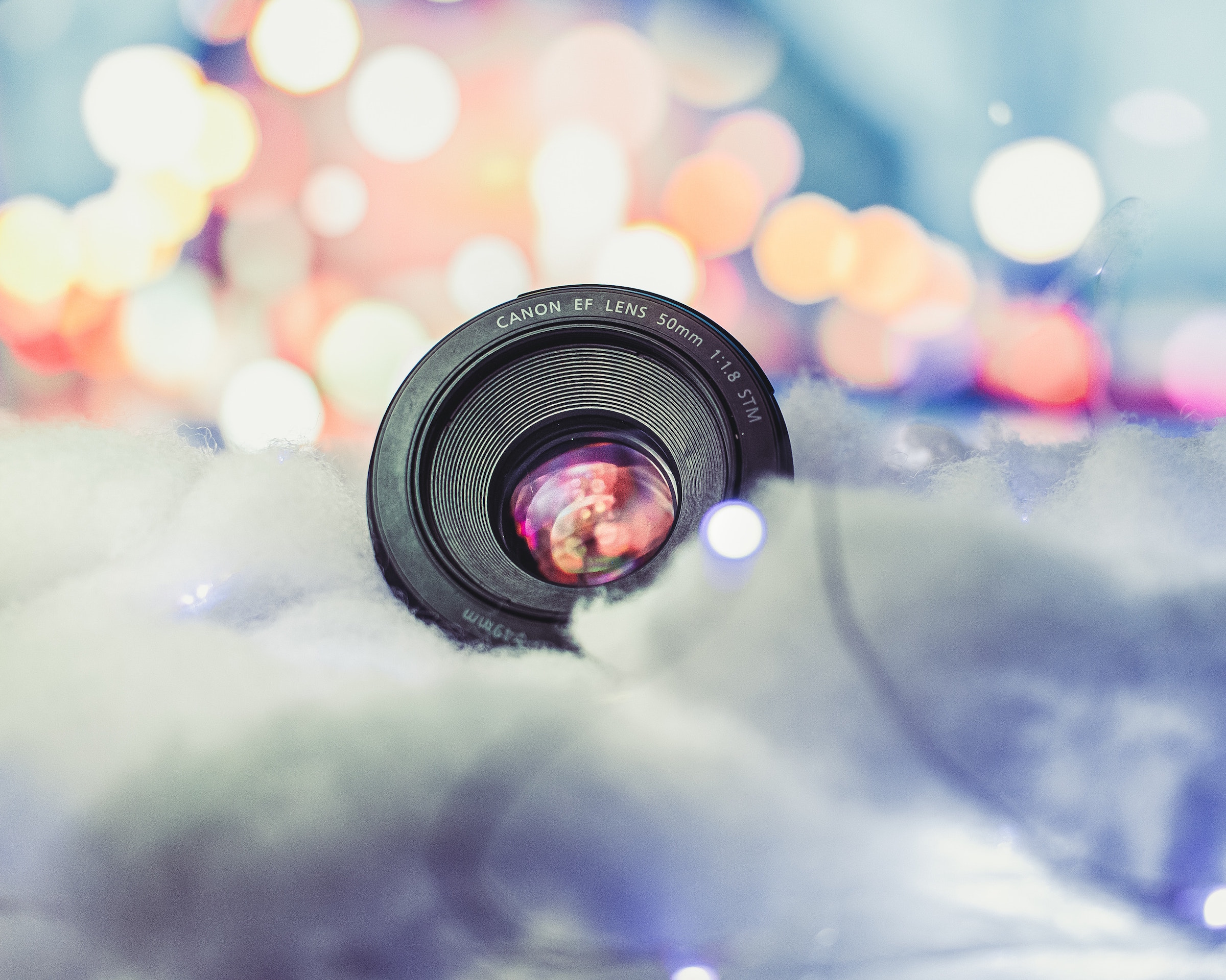 camera lens nestled in clouds and lights